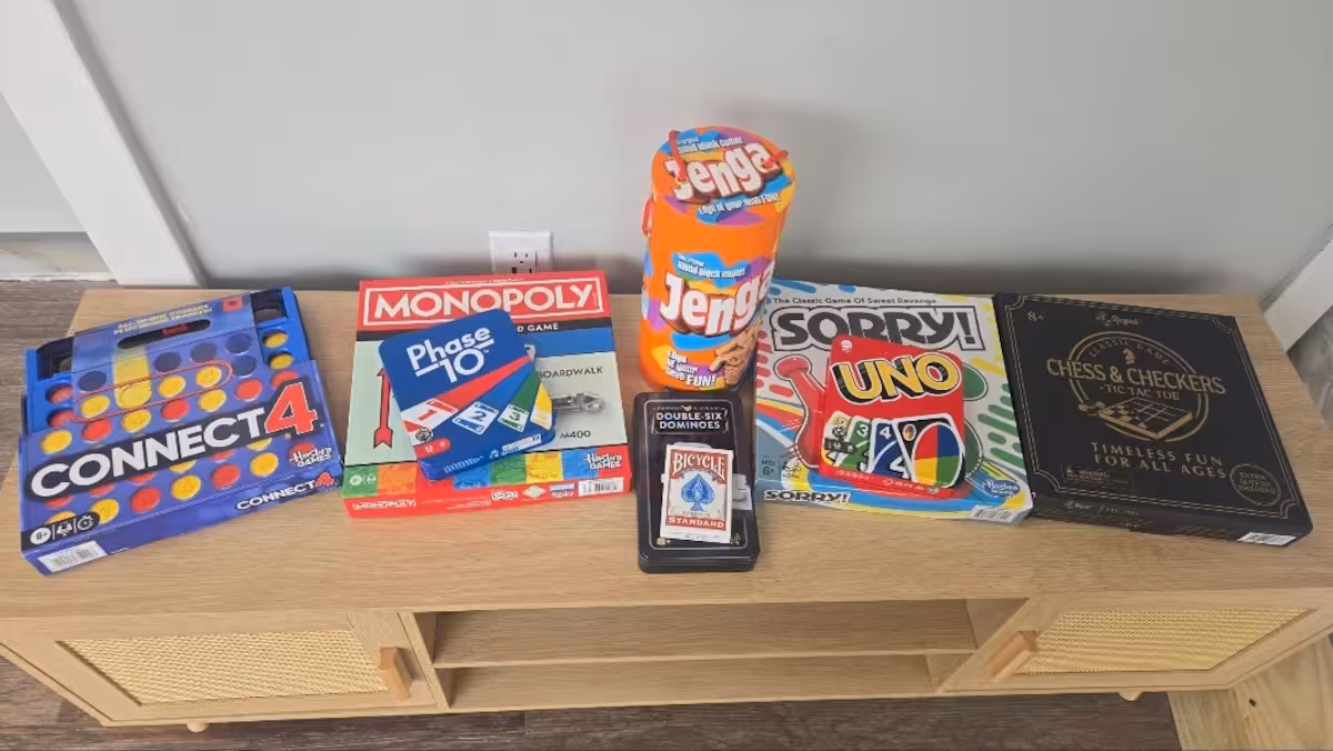 Board game collection at The Glamping Spot including Monopoly, Uno, Jenga, Connect 4, chess and dominoes